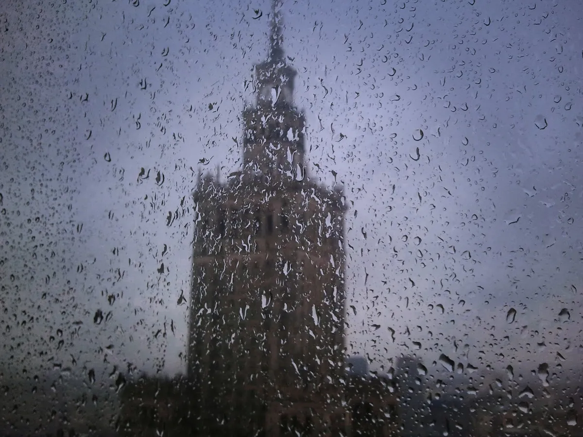 Blurred Palace of Culture and Science seen through a rain-covered window